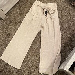 Lulus cream flare pants with tie belt. Never worn tags still on size M